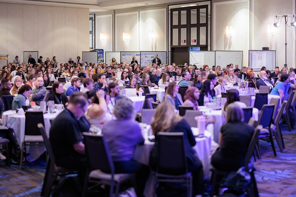 Conference Room full of attendees sitting at round tables