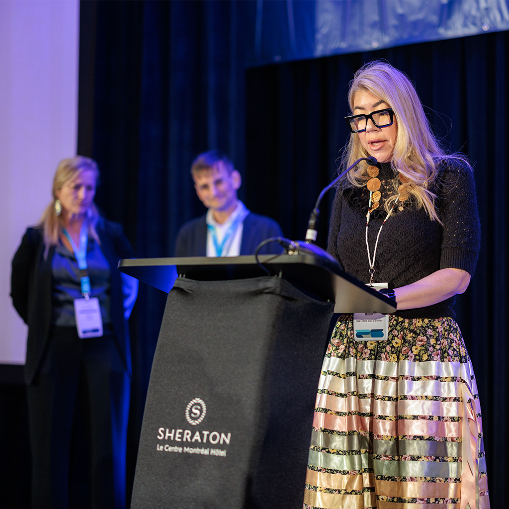 Woman speaking at podium at Sheraton